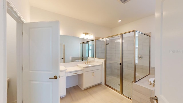 bathroom with separate shower and tub and vanity