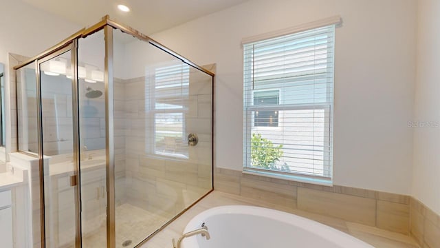 bathroom featuring vanity and independent shower and bath