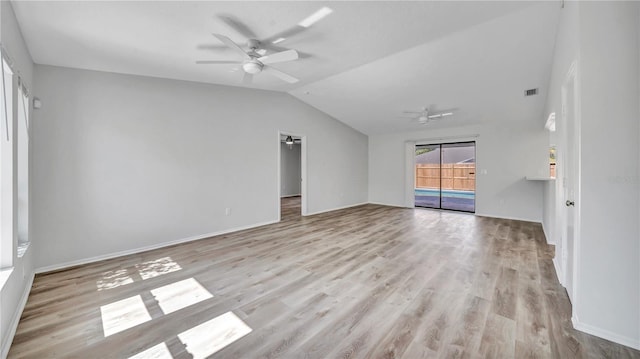 empty room featuring lofted ceiling, ceiling fan, and light wood-type flooring