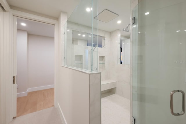 bathroom with walk in shower and hardwood / wood-style flooring