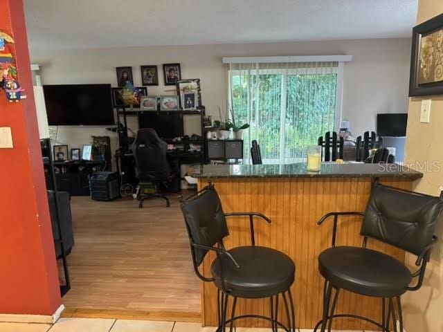 bar with light hardwood / wood-style floors