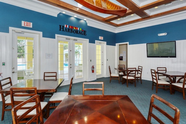 dining space featuring dark colored carpet, a healthy amount of sunlight, beam ceiling, and french doors