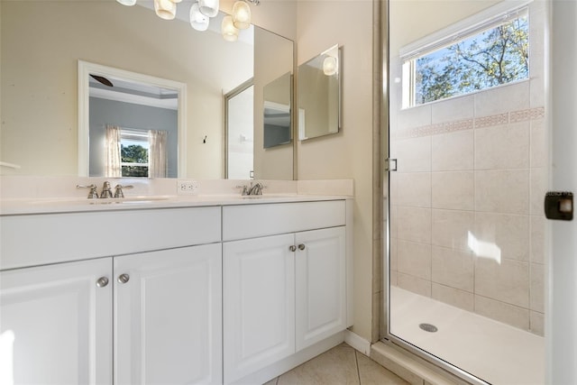 bathroom featuring tile patterned flooring, vanity, and a shower with shower door