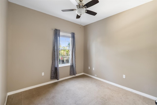 spare room featuring carpet floors and ceiling fan