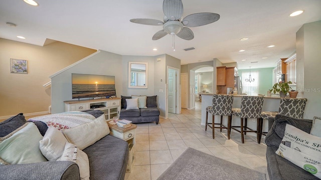 tiled living room with ceiling fan