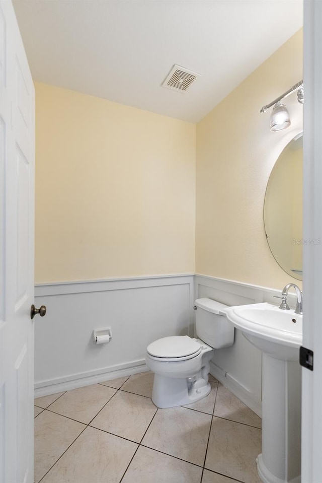 bathroom featuring tile patterned flooring and toilet