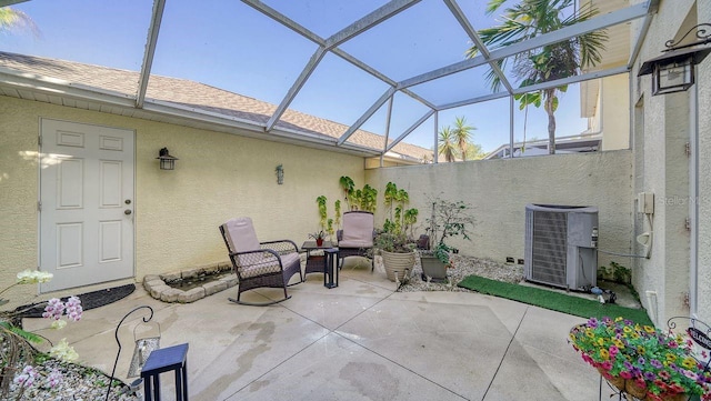 view of patio with a lanai and central AC unit