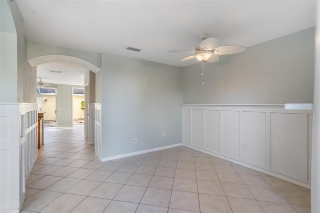 tiled empty room with ceiling fan