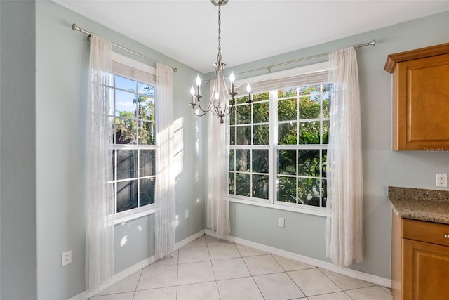 unfurnished dining area with light tile patterned floors and a notable chandelier