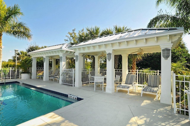 view of pool with an outbuilding, a gazebo, a patio area, and ceiling fan