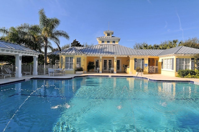 view of pool featuring french doors and a patio area