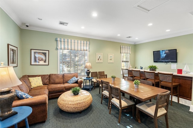 dining space with crown molding and carpet flooring