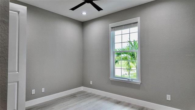 empty room featuring ceiling fan and light hardwood / wood-style flooring