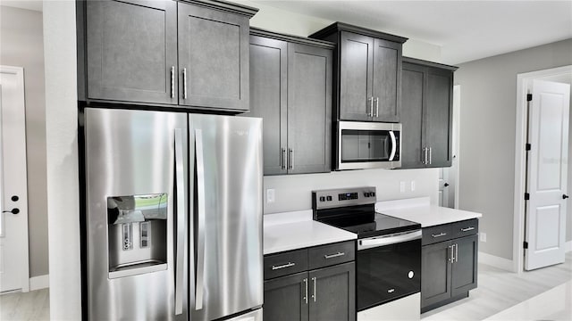 kitchen with stainless steel appliances and light wood-type flooring