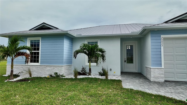 exterior space featuring a lawn and a garage