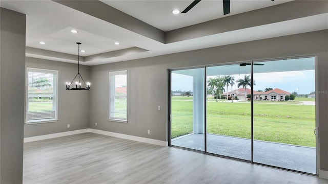 doorway to outside featuring ceiling fan with notable chandelier and light hardwood / wood-style floors