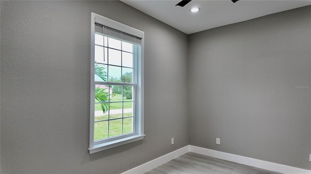 unfurnished room featuring ceiling fan and light wood-type flooring