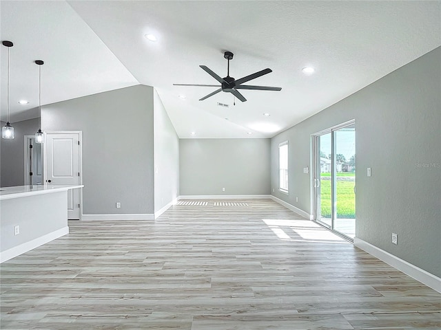 unfurnished living room with ceiling fan, light hardwood / wood-style flooring, and vaulted ceiling