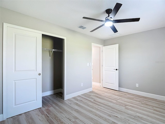 unfurnished bedroom with a closet, light hardwood / wood-style floors, and ceiling fan