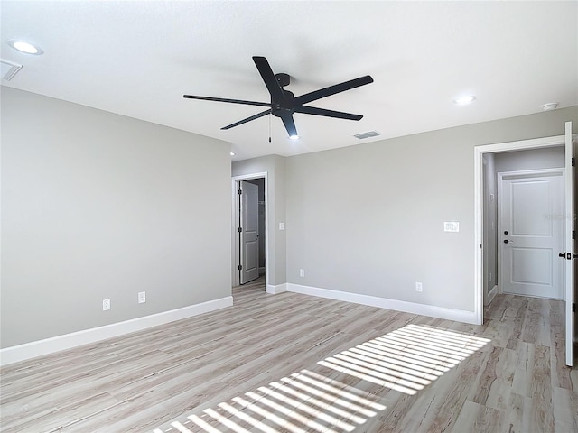 spare room with light wood-type flooring and ceiling fan