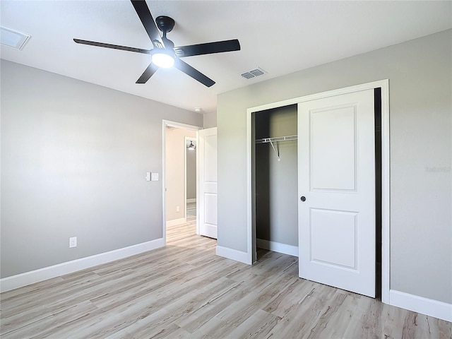 unfurnished bedroom with ceiling fan, light hardwood / wood-style flooring, and a closet