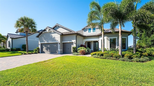 view of front facade featuring a front yard and a garage