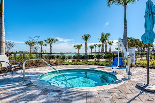 view of swimming pool featuring a hot tub and a patio