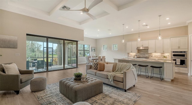 living room with coffered ceiling, light hardwood / wood-style flooring, beamed ceiling, and ceiling fan