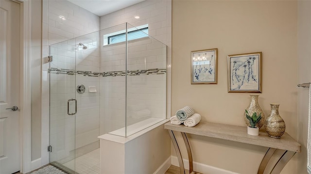 bathroom with a shower with door