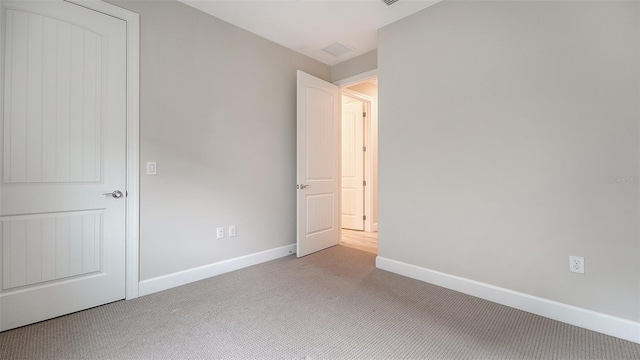 unfurnished bedroom featuring light carpet