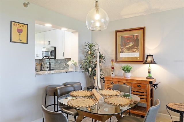 dining space featuring a textured ceiling