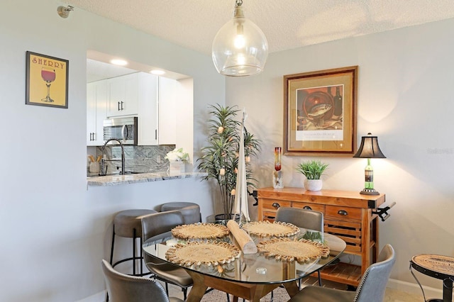 dining room with a textured ceiling