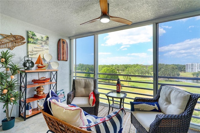 sunroom featuring ceiling fan