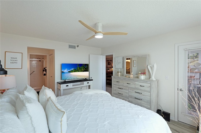 bedroom featuring ceiling fan, a textured ceiling, and light wood-type flooring