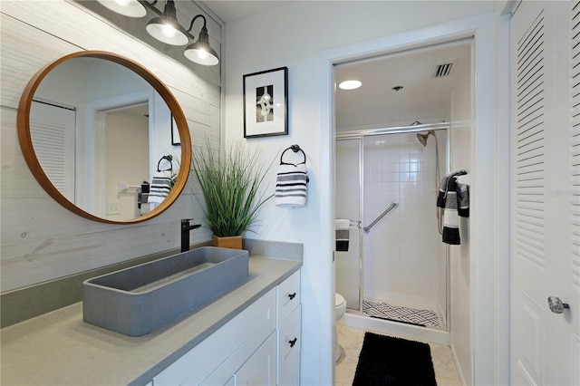 bathroom with wood walls, toilet, vanity, and walk in shower