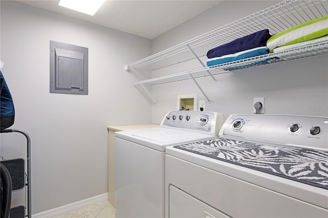 laundry room featuring washing machine and dryer, electric panel, and light tile patterned floors