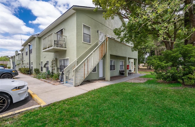 exterior space featuring a yard and a balcony