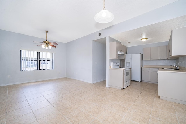 kitchen with sink, white appliances, light tile flooring, and ceiling fan