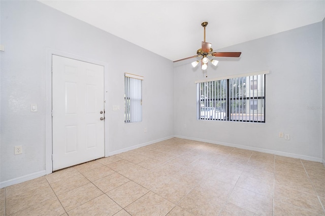 tiled spare room with ceiling fan