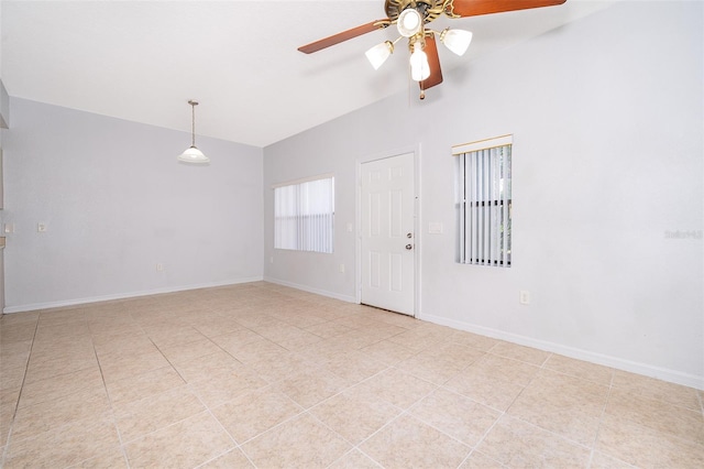 tiled empty room featuring ceiling fan