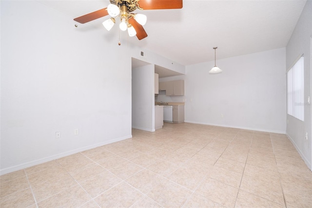 empty room with ceiling fan and light tile flooring