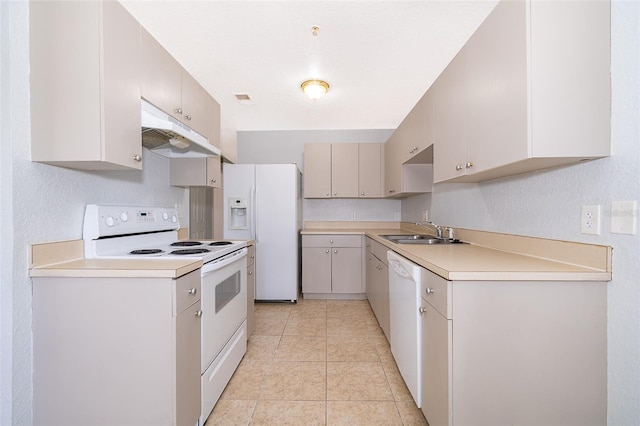 kitchen with white appliances, sink, and light tile floors