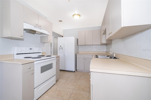 kitchen with sink, white appliances, light tile flooring, and gray cabinets