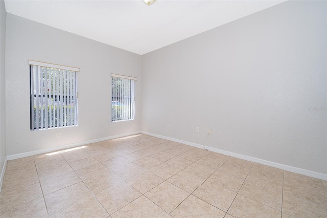 spare room with light tile floors