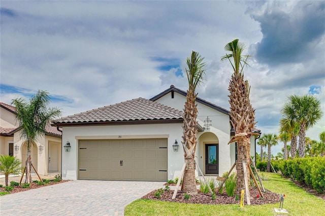 mediterranean / spanish-style home with a garage