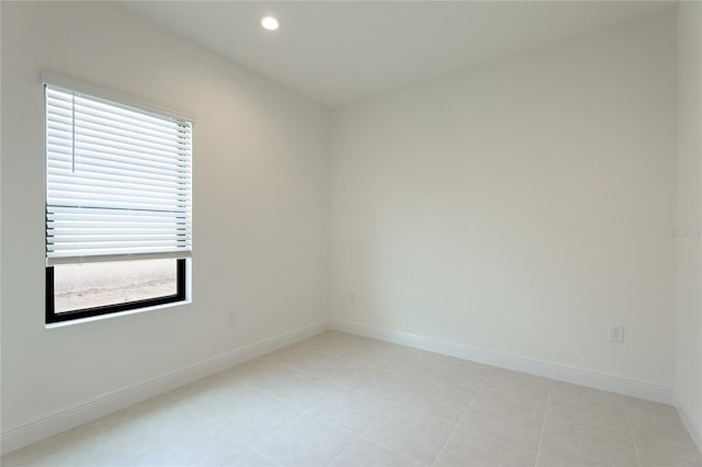 unfurnished room featuring light tile patterned flooring