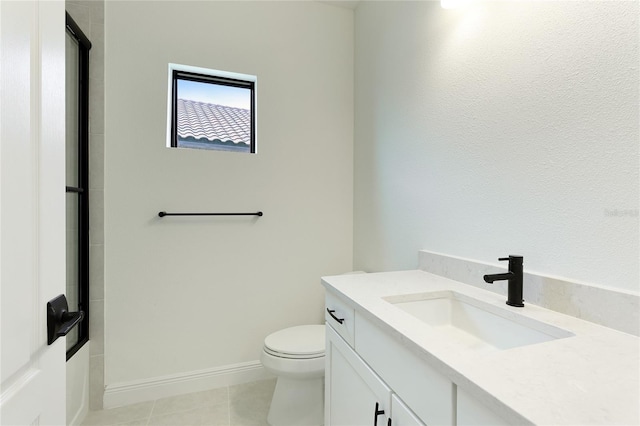 bathroom featuring tile patterned flooring, vanity, and toilet