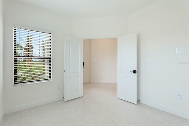 unfurnished room with light tile patterned floors