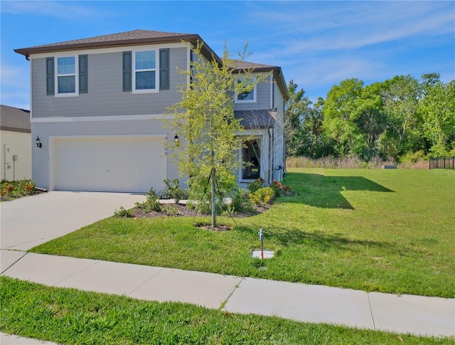 view of front of property with a garage and a front yard