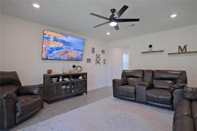 living room featuring wood-type flooring and ceiling fan